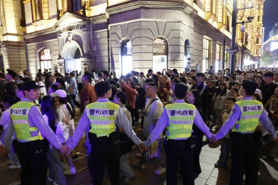 黄浦民警引导游客有序前往江堤。中新网记者 殷立勤 摄 黄浦民警引导游客有序前往江堤。中新网记者 殷立勤 摄