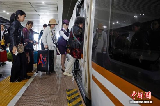 列车长陈颖帮助老年旅客上车。中新网记者 殷立勤 摄 列车长陈颖帮助老年旅客上车。中新网记者 殷立勤 摄